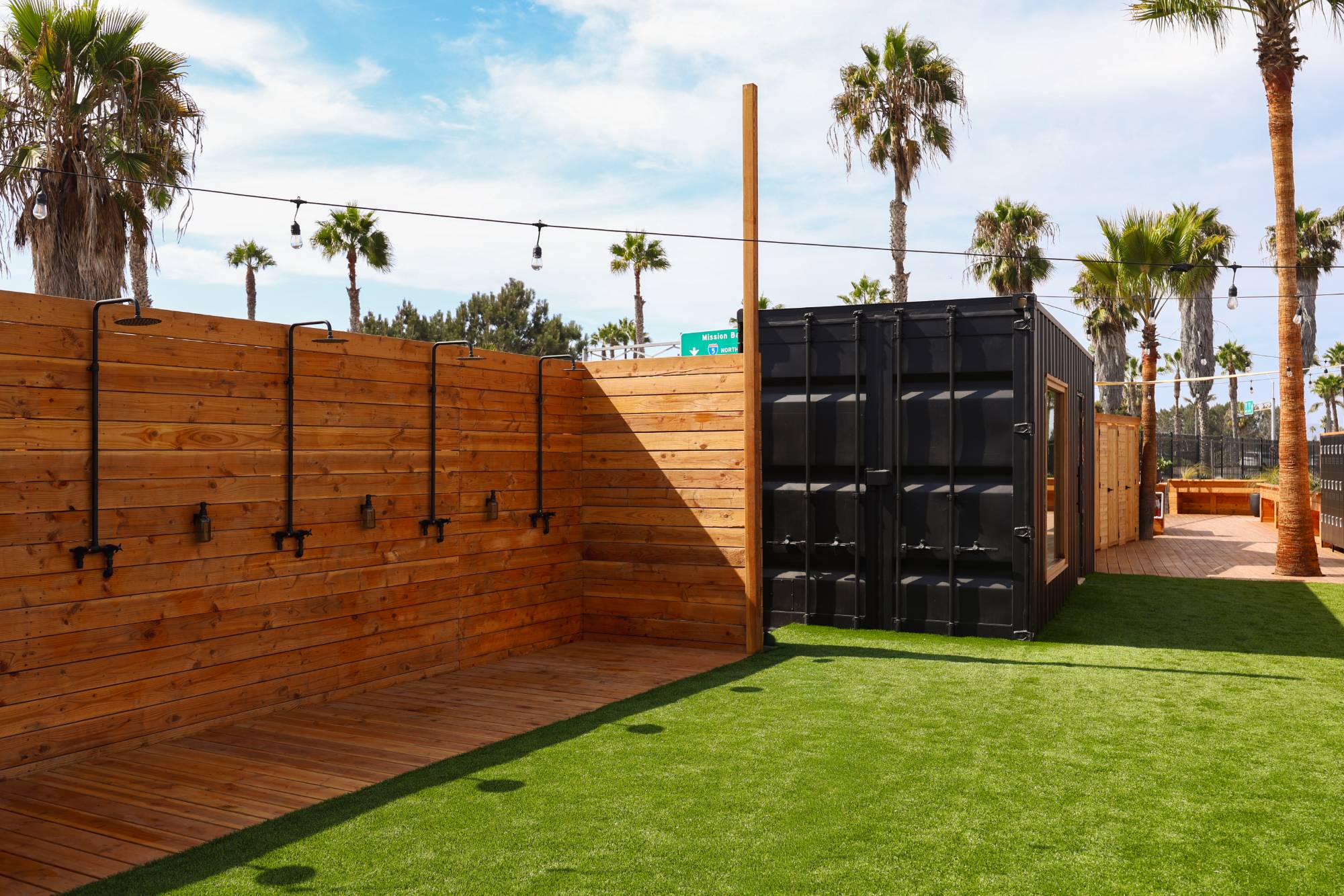 Outdoor rain showers along a cedar wall