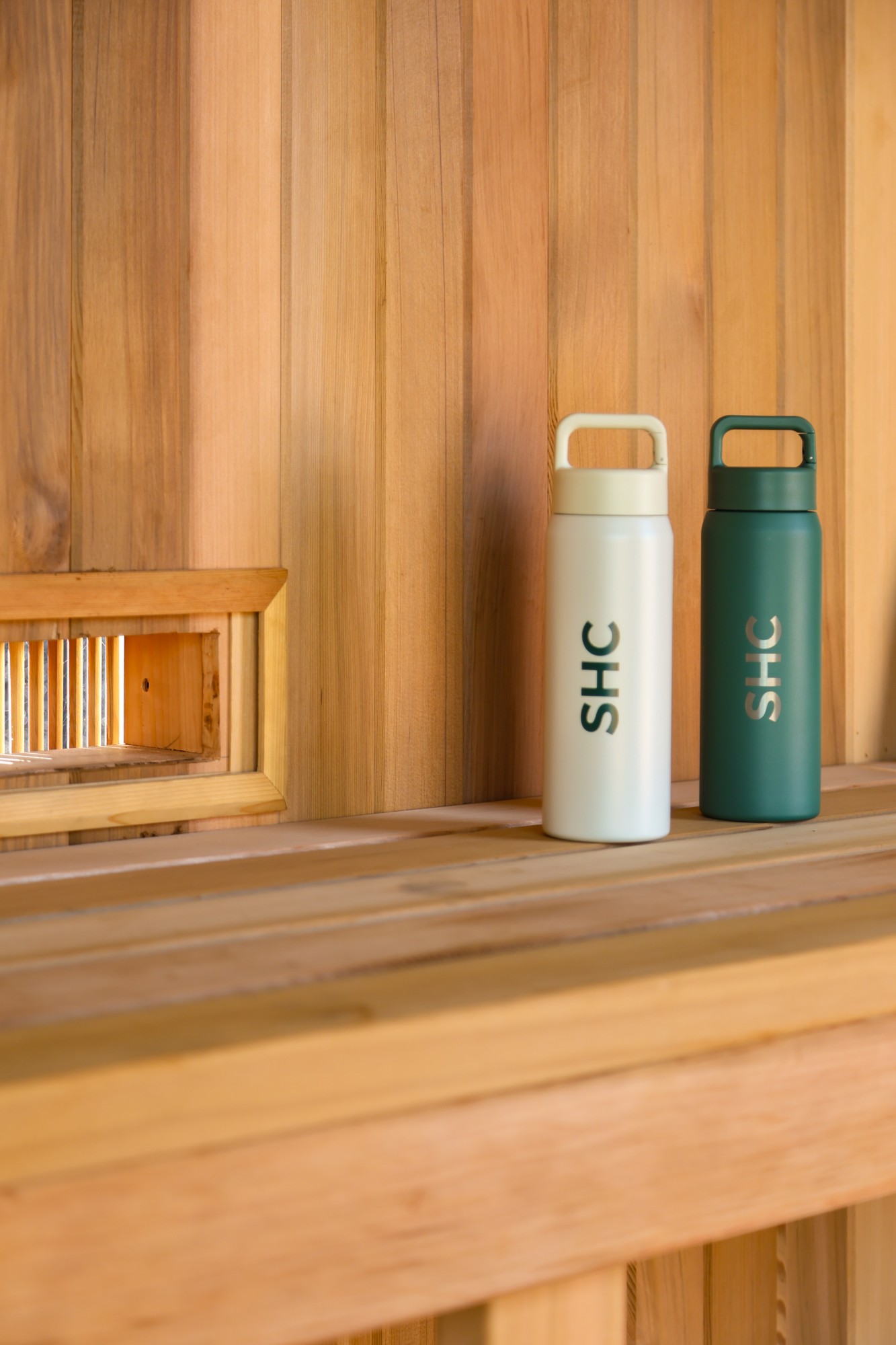 SHC water bottles on a cedar sauna bench